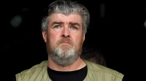 Getty Images Paul Gallagher watches Liam Gallagher performs on the Pyramid stage during day four of Glastonbury Festival at Worthy Farm in June 2019