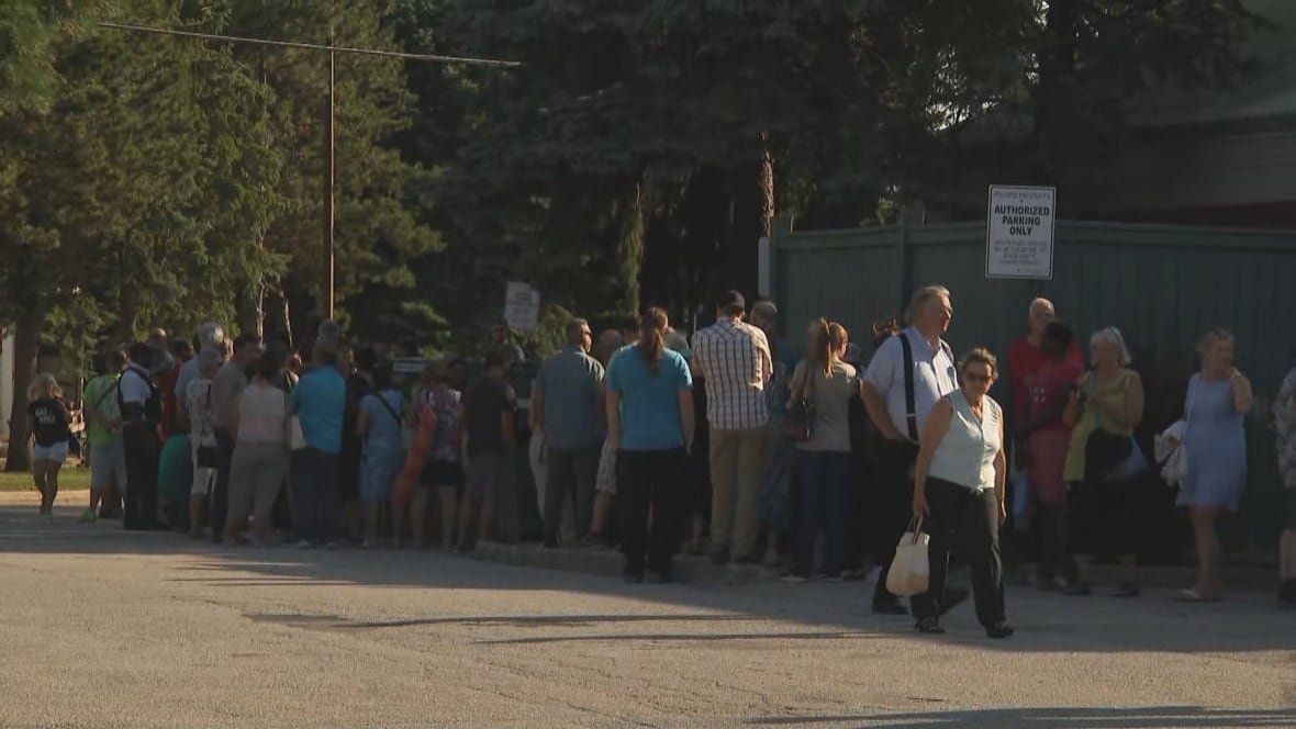 people line up around the edge of a building