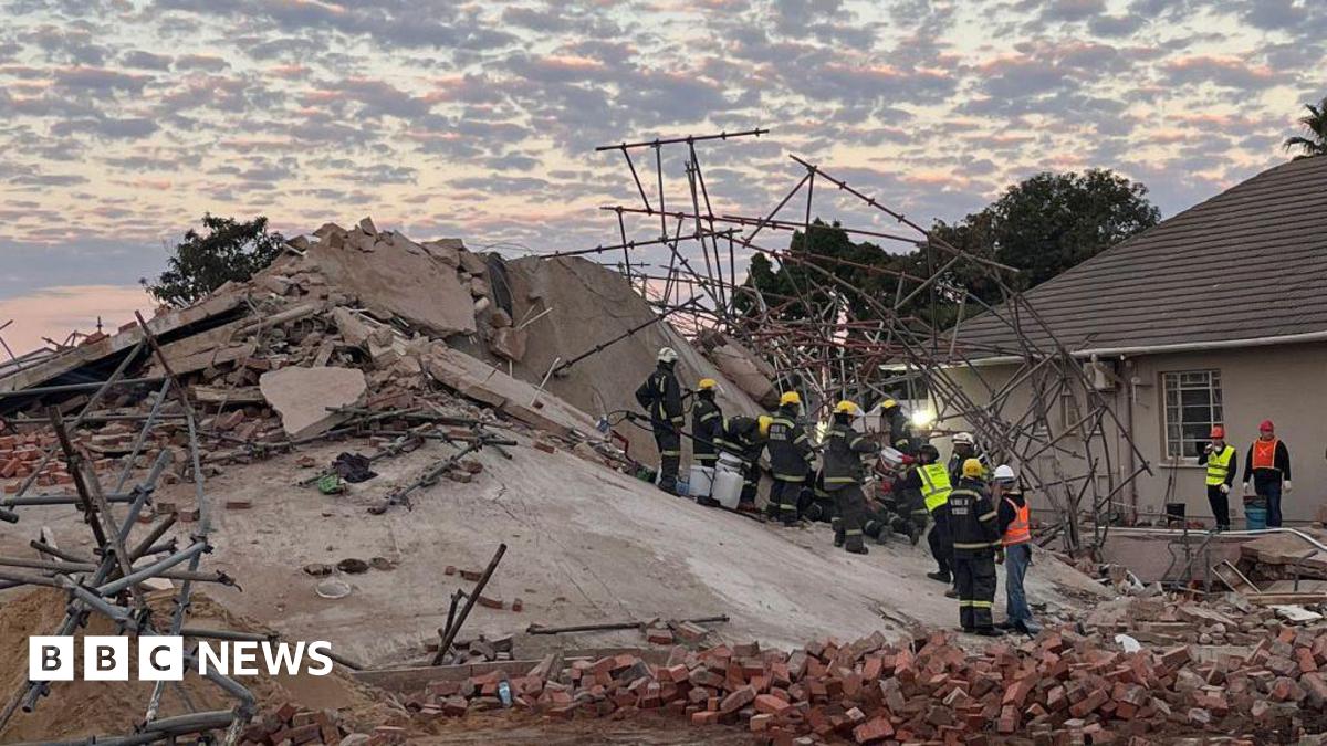 Rescue workers are seen at the scene of a collapsed building in George on May 7, 2024.