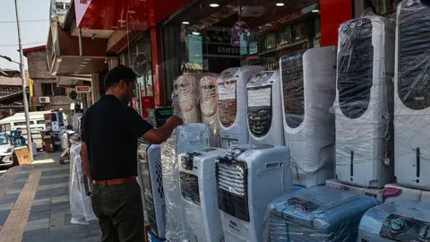 Getty Images People purchase air coolers, fans, and other cooling equipment amid hot weather conditions in Srinagar, Jammu and Kashmir, India, on June 20, 2025. Kashmir experiences a dramatic and unprecedented rise in maximum temperatures, with several weather stations across the Valley surpassing decades-old records. (Photo by Nasir Kachroo/NurPhoto via Getty Images)