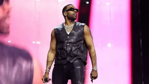 Getty Images Mario performs in a black leather outfit