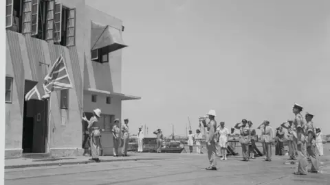 Bettmann via Getty Images A British marine lowers the Union Flag to officially end British rule in the Palestine in 1948 