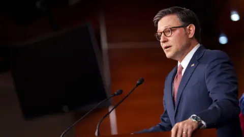 EPA House Speaker Mike Johnson standing at a podium