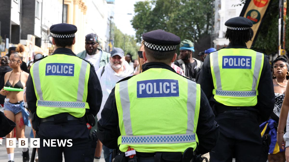 A general view of the back of three Metropolitan Police officers at Notting Hill Carnival.