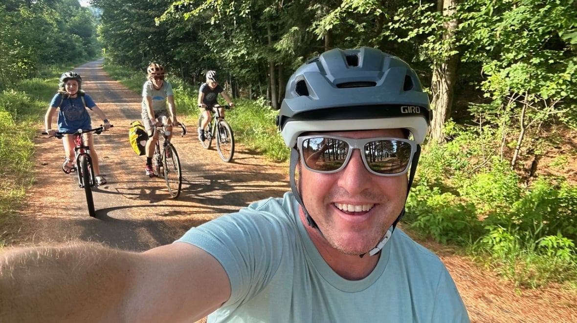 A man in a bicycle helmet and sunglasses