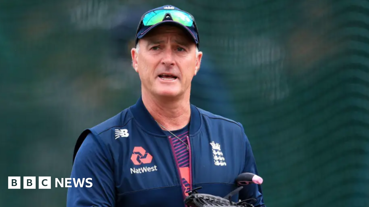 An image of former England and Surrey cricketer Graham Thorpe. He is wearing a new balance gilet with England and Natwest emblems. He is wearing a cap and sunglasses.