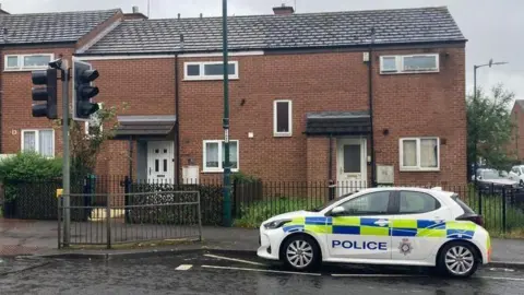A police car outside a house in Radford in Nottingham