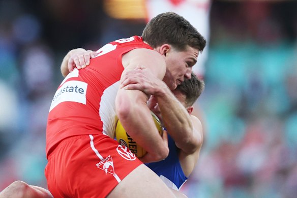 Angus Sheldrick of the Swans is tackled.