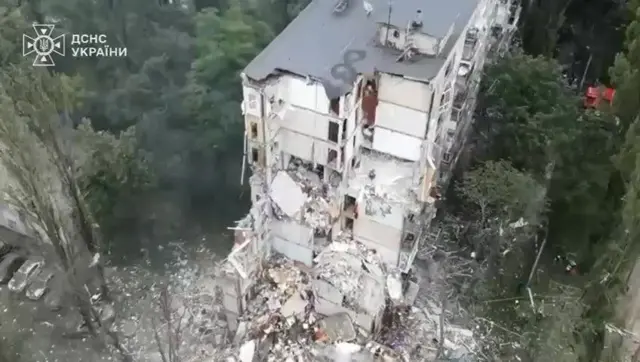 A still image of a partially collapsed building