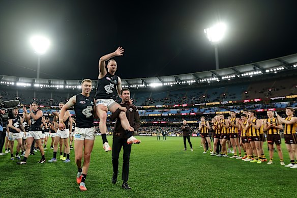 Sam Docherty of the Blues is chaired off the ground following his final game.