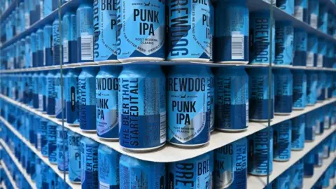 Getty Images Bright blue cans of Brewdog's Punk IPA stacked to the ceiling