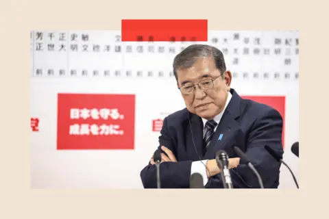 EPA  Shigeru Ishiba folds his arms and speaks to the media via multiple microphones