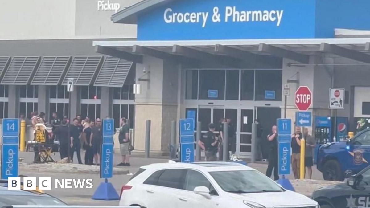 Emergency personnel stand outside a Walmart store, where a stabbing incident occurred, in Traverse City, Michigan