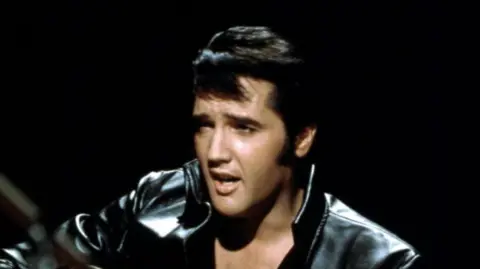 Getty Images Elvis Presley  performing on the Elvis comeback TV special on 27 June, 1968. He is wearing a black leather jacket.