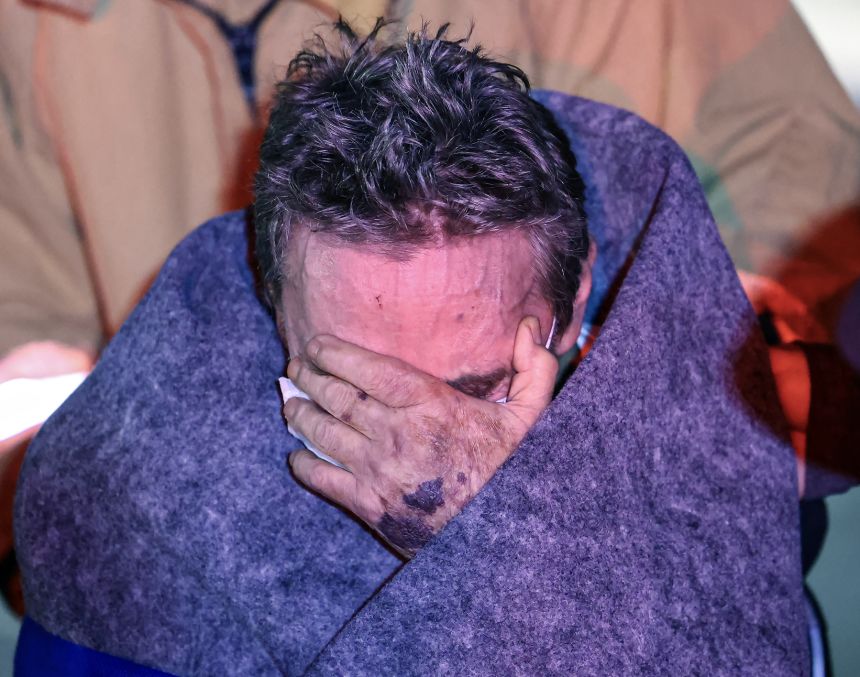 A resident of the Gabriel House Assisted Living facility reacts after a fire displaced several residents and caused injuries.