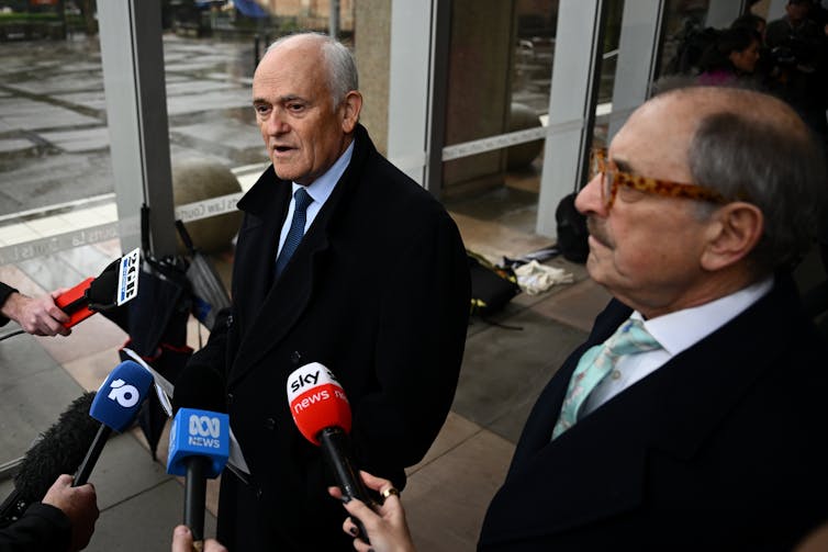 Peter Wertheim and Robert Goot speaking with the media outside the Federal Court.