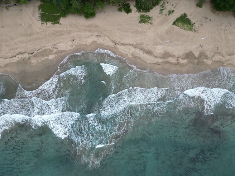 a beach with waves crashing to shore