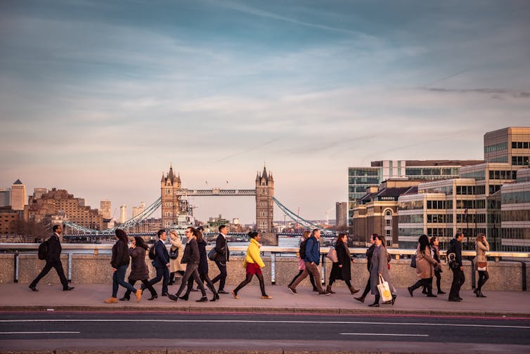 Commuters walking across London Bridge.