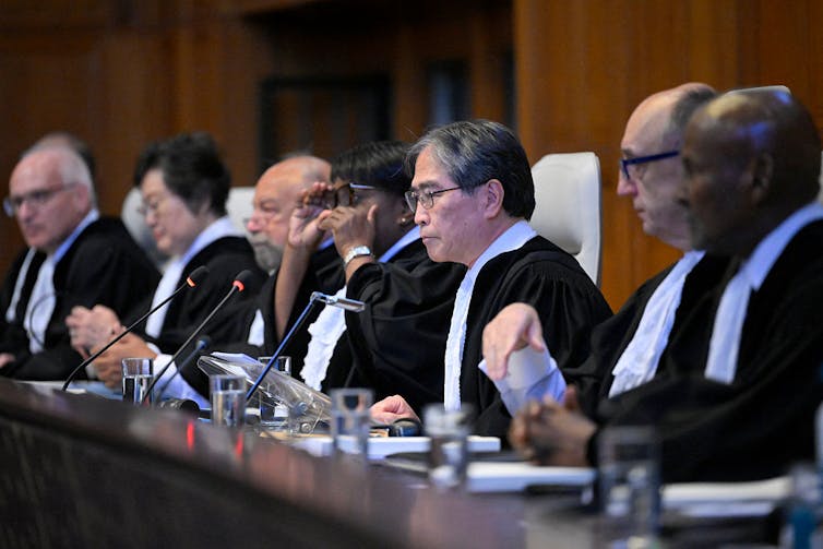 Seven judges sitting at a bench