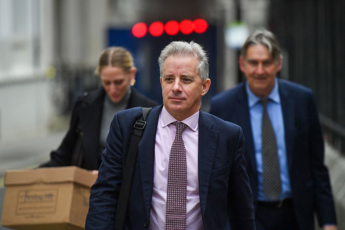 Christopher Steele, ex-MI6 agent, center, departs from the Royal Courts of Justice in London, UK, on Monday, Oct. 16, 2023.