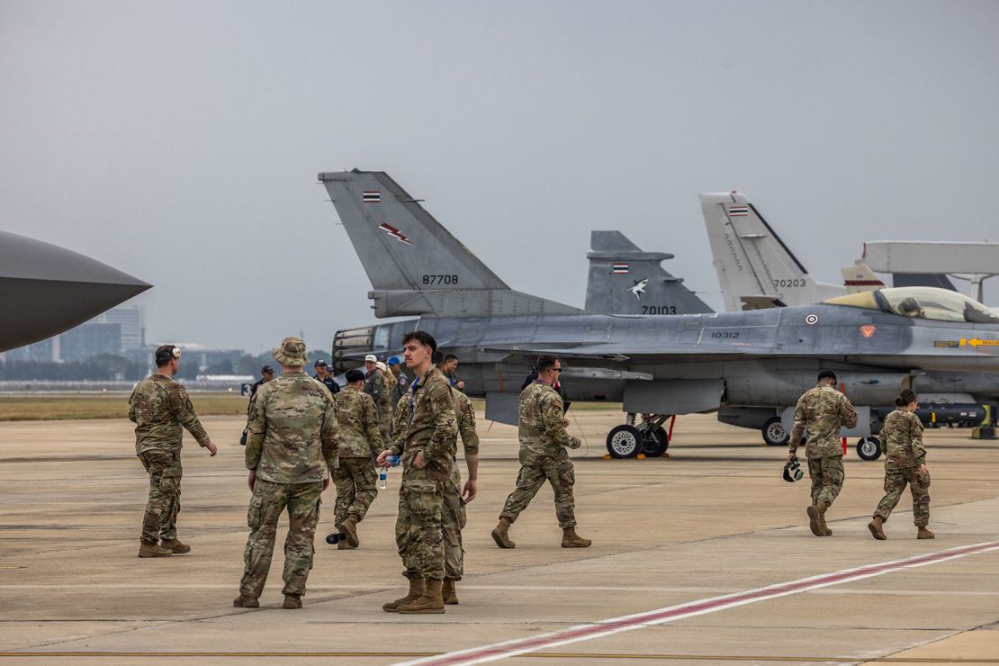 US Air Force personnel walk past planes on display at Thailand's 88th Royal Air Force Anniversary Air Show on March 7, 2025 in Bangkok, Thailand.
