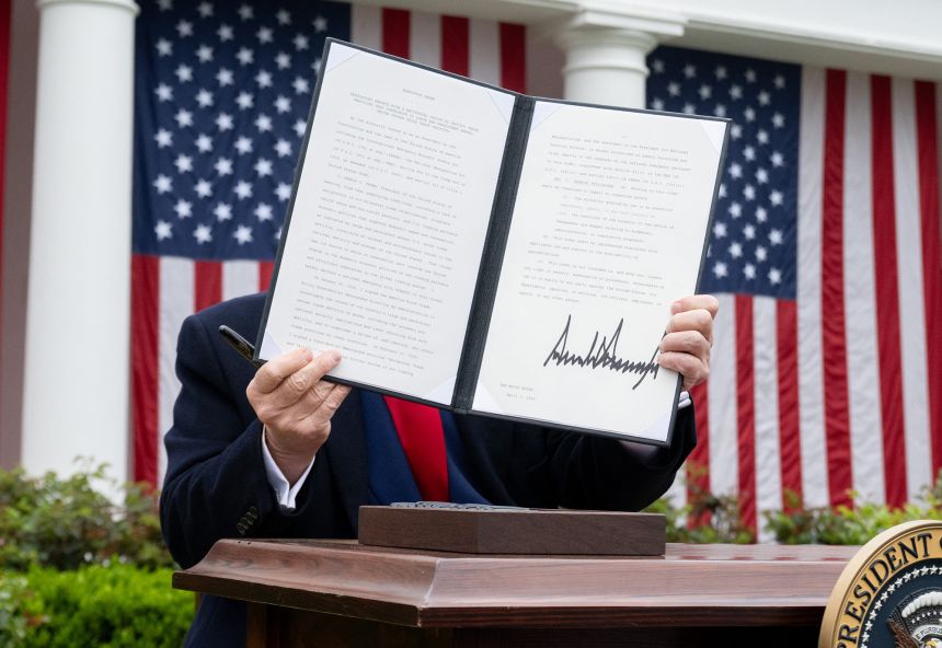 US President Donald Trump holds a signed executive order after delivering remarks on reciprocal tariffs during an event in the Rose Garden entitled 