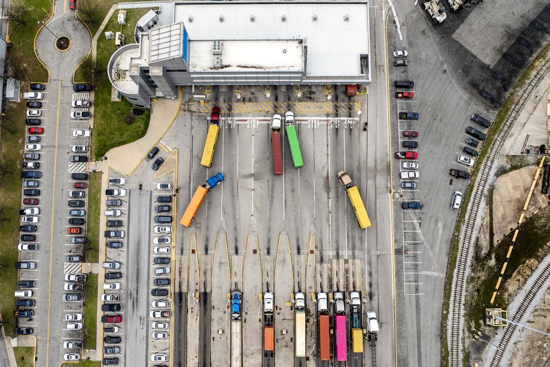 This aerial view shows semi-trailer trucks carrying shipping containers waiting to enter the Port of Baltimore on April 10 in Maryland.