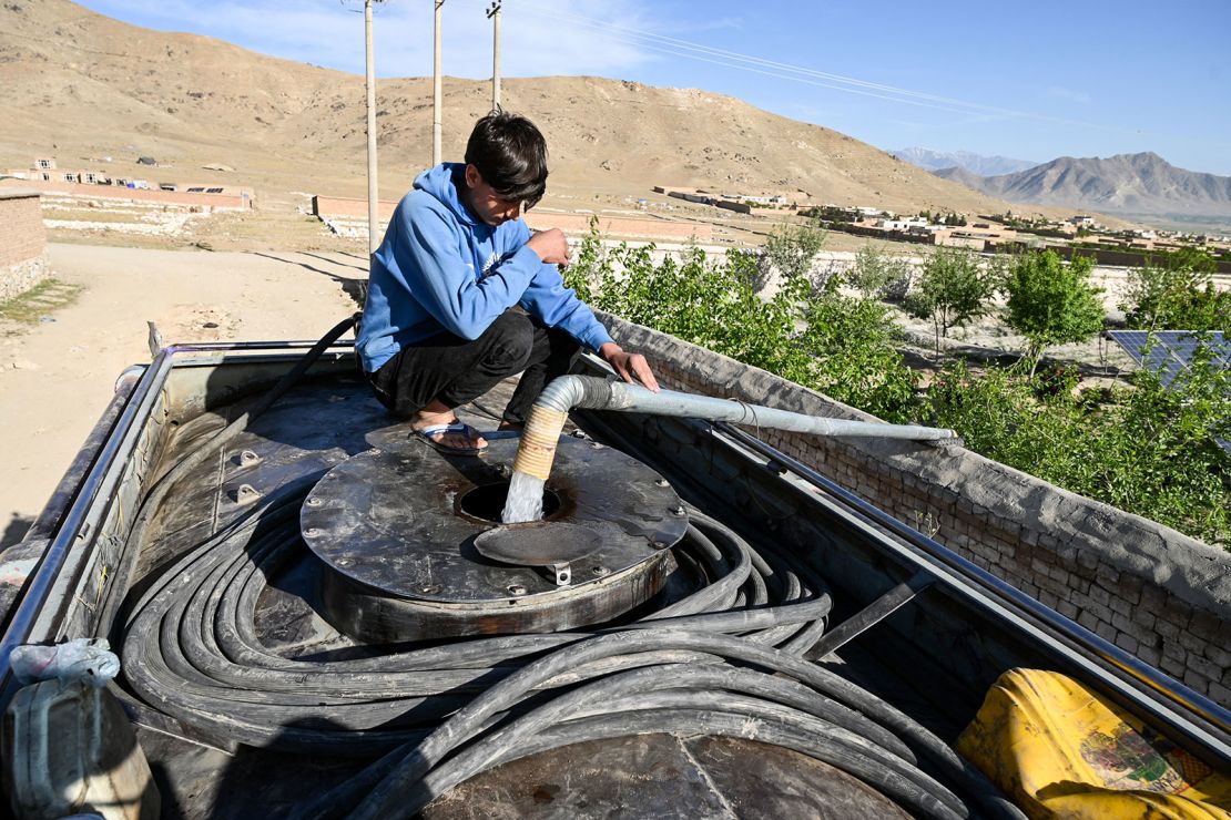 An Afghan boy fills his potable water tanker from a pump on the outskirts of Kabul on April 27, 2025.