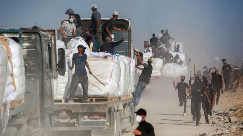 Under attack from all sides, armed clans try to protect aid coming into Gaza