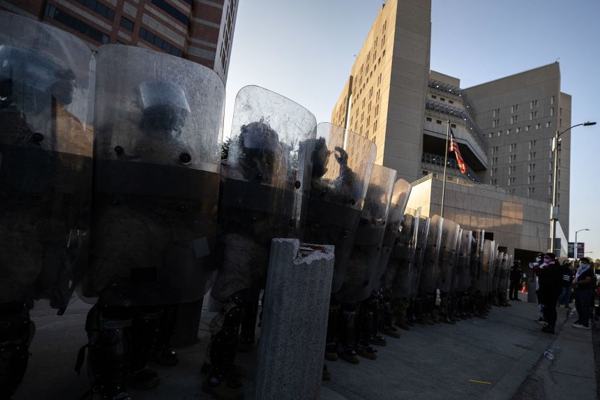 Marines and National Guardsmen stand in front of the entrance of the Metropolitan Detention Center in Los Angeles, during a protest held on July 4.