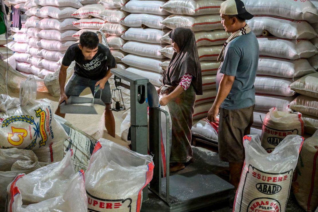 Workers prepare customers' orders at the main rice market in Jakarta, Indonesia, on July 9, 2025.