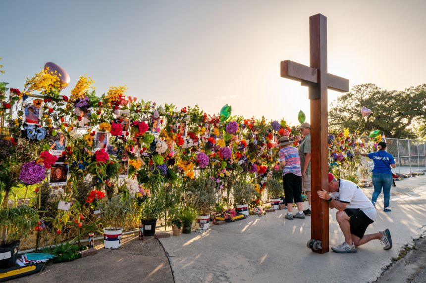 Community residents pay their respects at a memorial on July 10, 2025, in Kerrville, Texas.