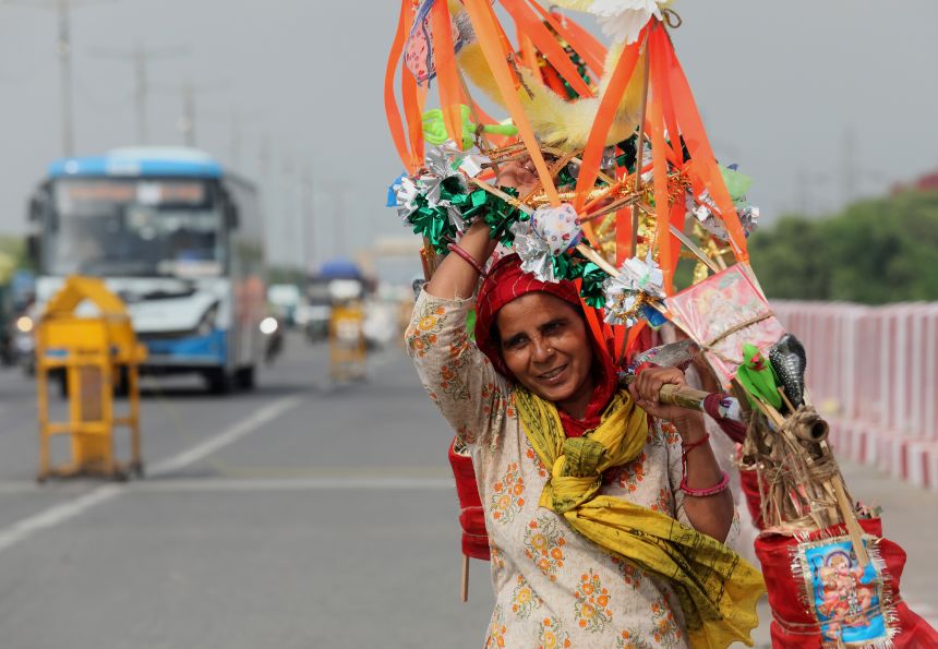 A Lord Shiva devotee carries sacred Ganga Jal (holy water) during the ongoing Kanwar Yatra in New Delhi, India on July 15, 2025.