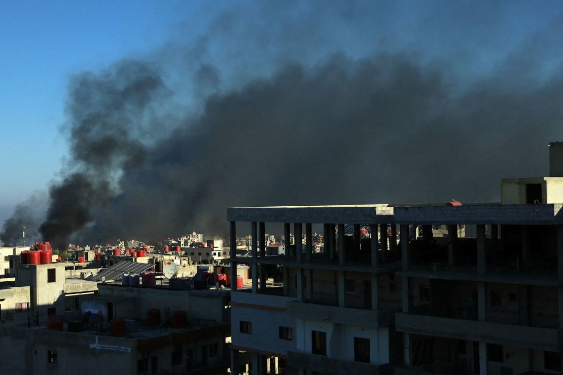 Black smoke rises above buildings in southern Syria's city of Suwayda on Saturday.