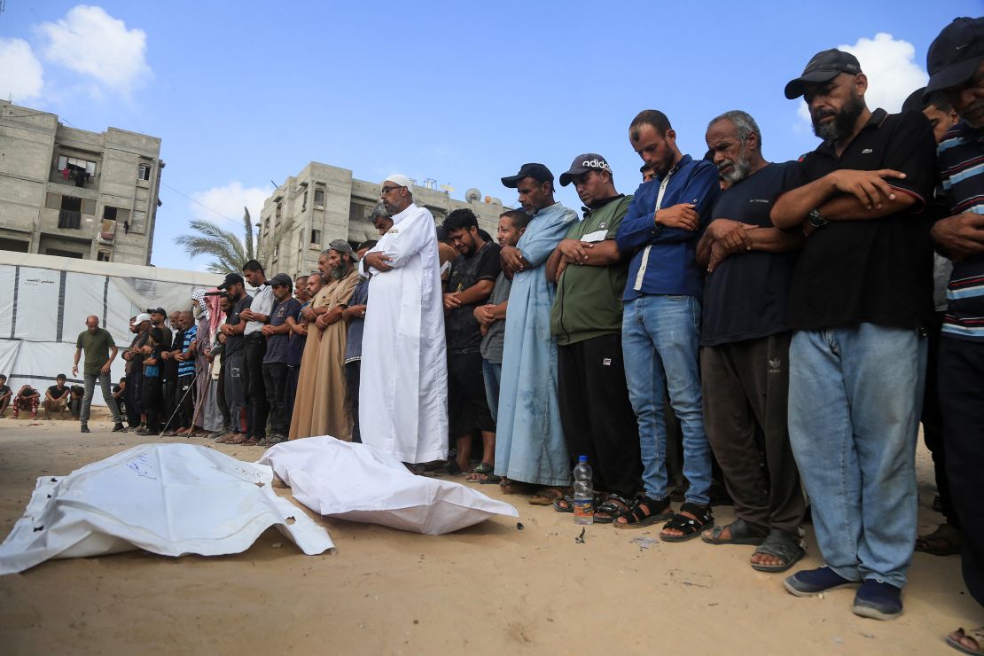 Palestinians recite a prayer over a body at the Nasser hospital on July 19, 2025. 