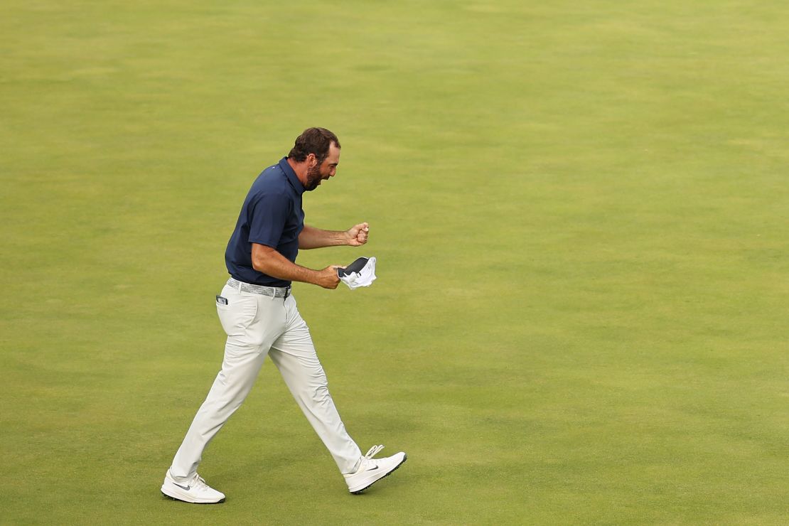Scottie Scheffler celebrates on the 18th green after winning his fourth major title.