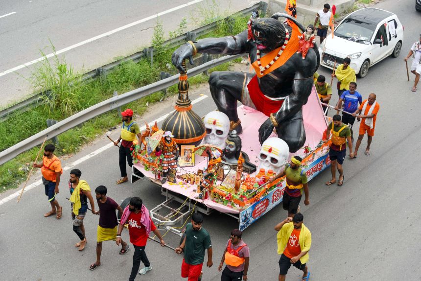 A group of Kanwariyas carry holy water from the Ganga River in Haridwar to Gurugram, during the Kanwar Yatra on July 21, 2025.