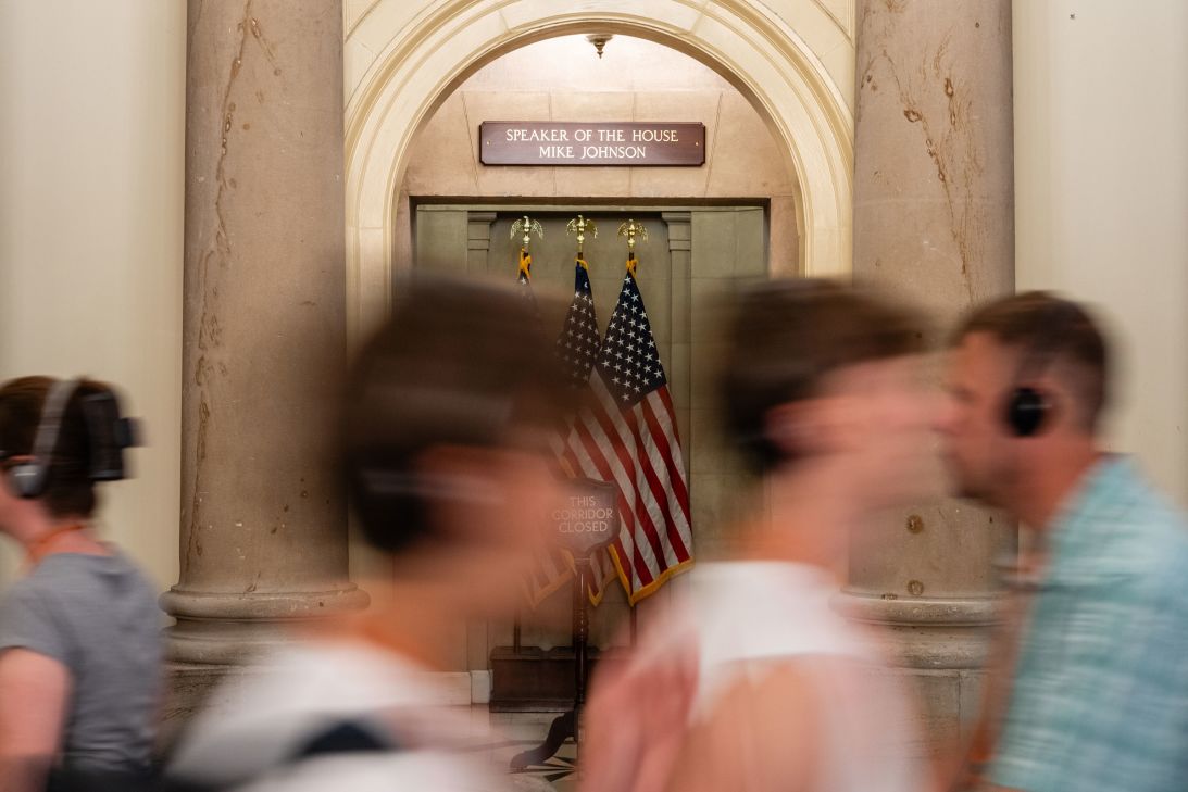 Visitors pass Speaker of the House Mike Johnson's office at the US Capitol on Tuesday.