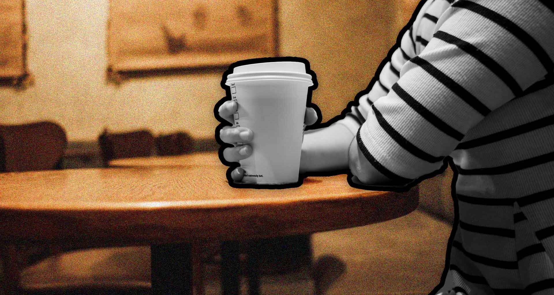 A close up image of someone drinking a takeaway coffee.