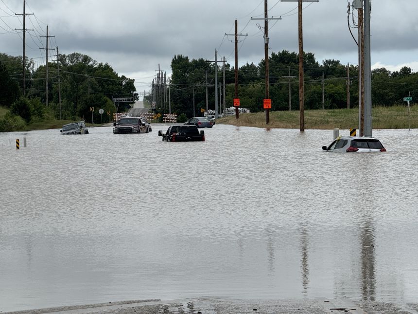 Vehicles were submerged in floodwater after heavy rain in the earliest hours of Thursday morning in the greater Kansas City metro.