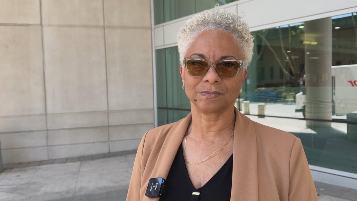 Linda stands outside of courthouse