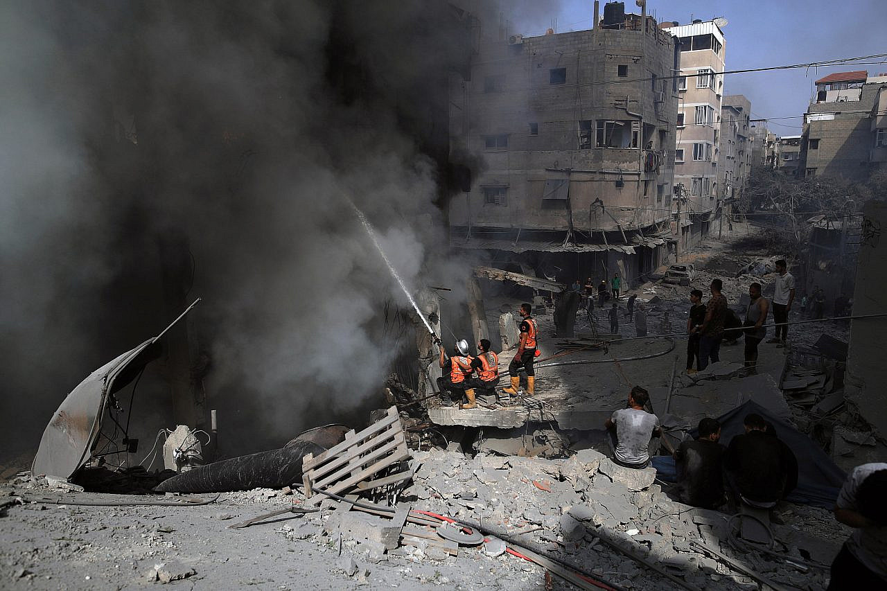 Members of the Civil Defense intervene in the immediate aftermath of an Israeli bombing in the Sheikh Radwan area north of Gaza City, October 23, 2023. (Mohammed Zaanoun/Activestills)