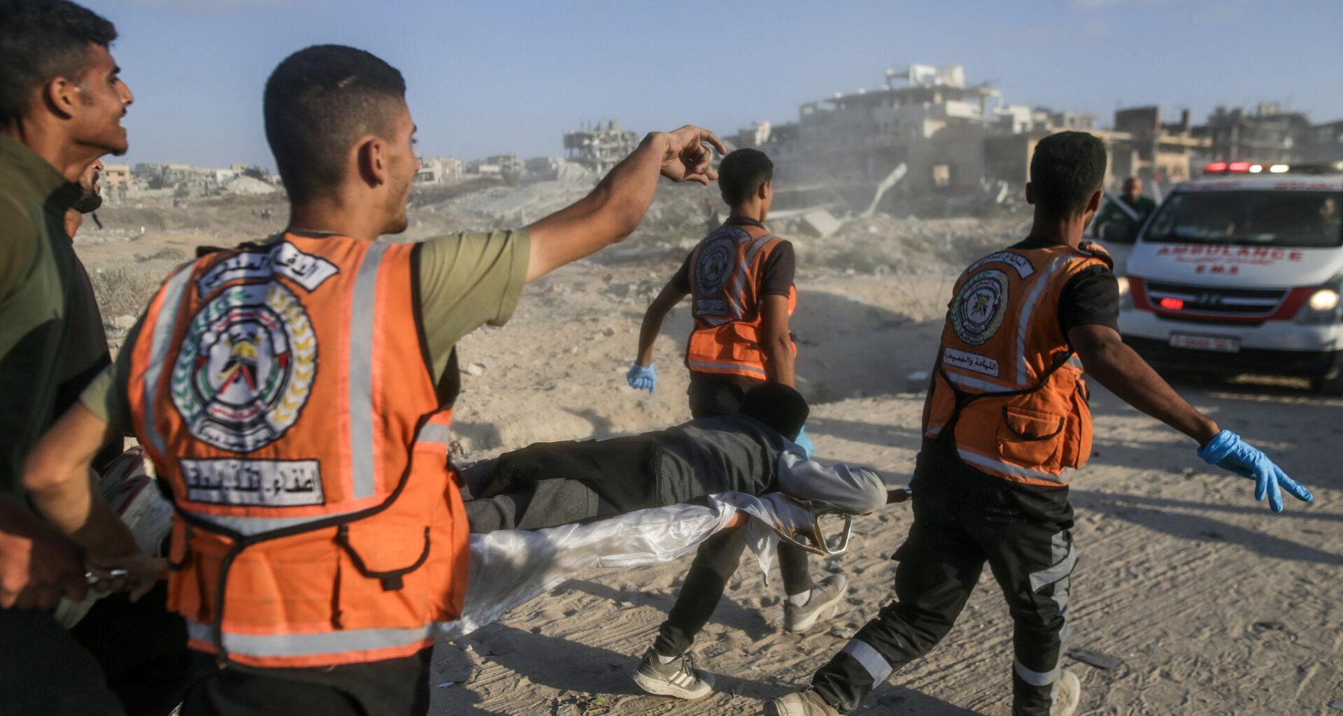 Medics rush to rescue a Palestinian wounded at an aid site in northern Gaza City, June 17, 2025. (Yousef Zaanoun/Activestills)