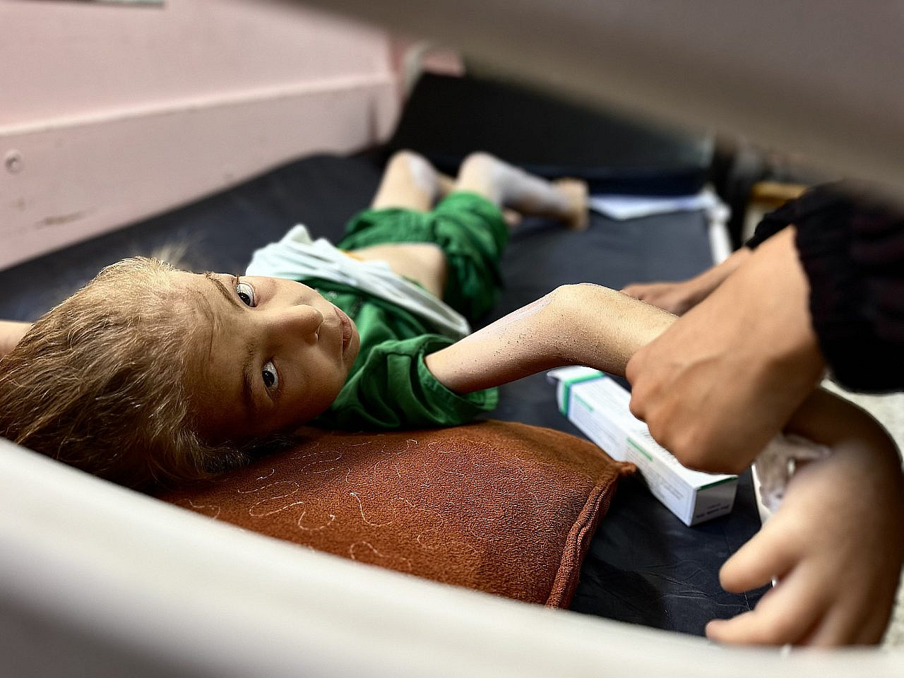 12-year-old Huda Abu Al-Naja, accompanied by her mother, receives treatment for malnutrition at Nasser Hospital in Khan Younis, southern Gaza Strip, June 25, 2025. (Doaa Albaz/Activestills)