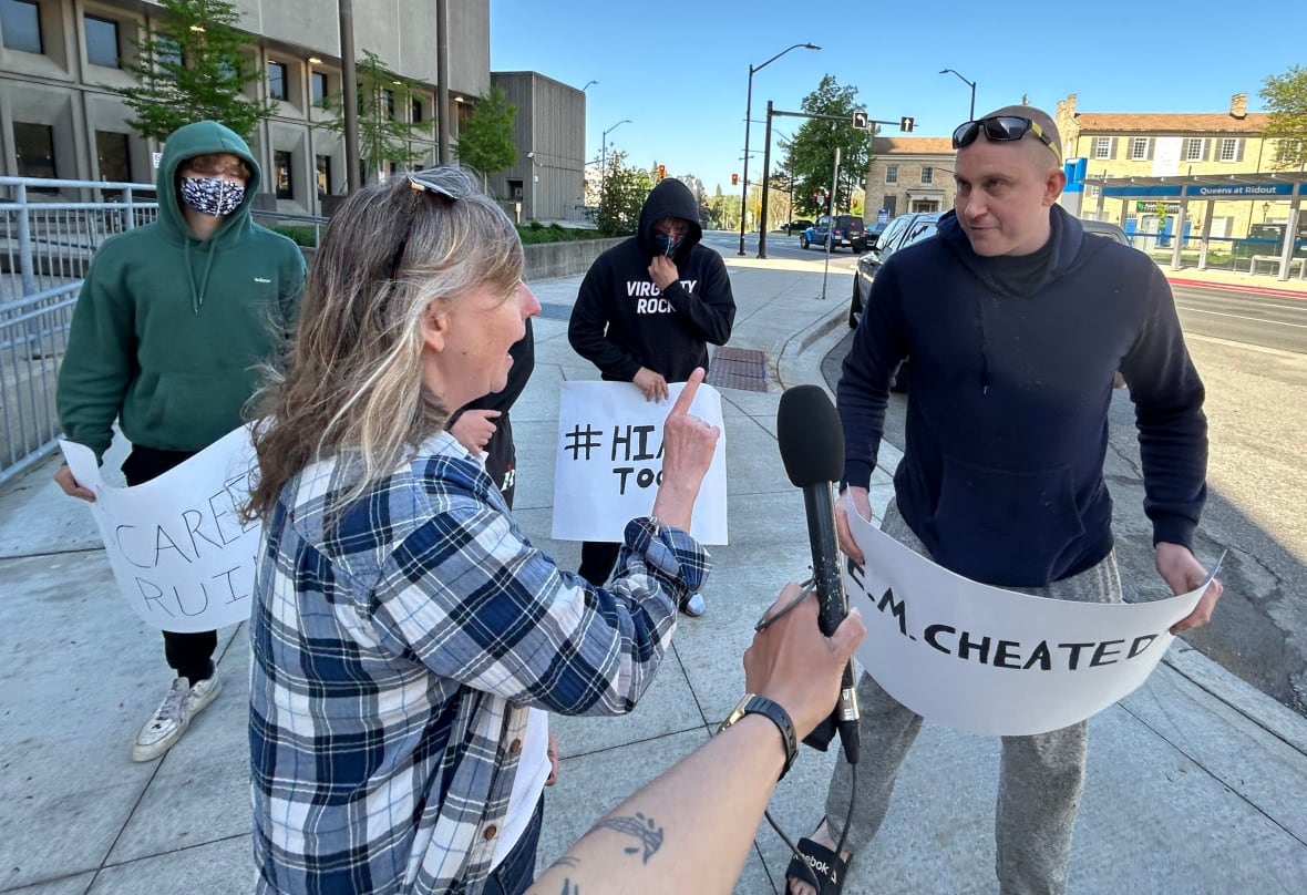 A woman supporting the complainant in a sexual assault trial involving five former world junior hockey players confronts a man supporting the men outside the London, Ont., courthouse on May 16.