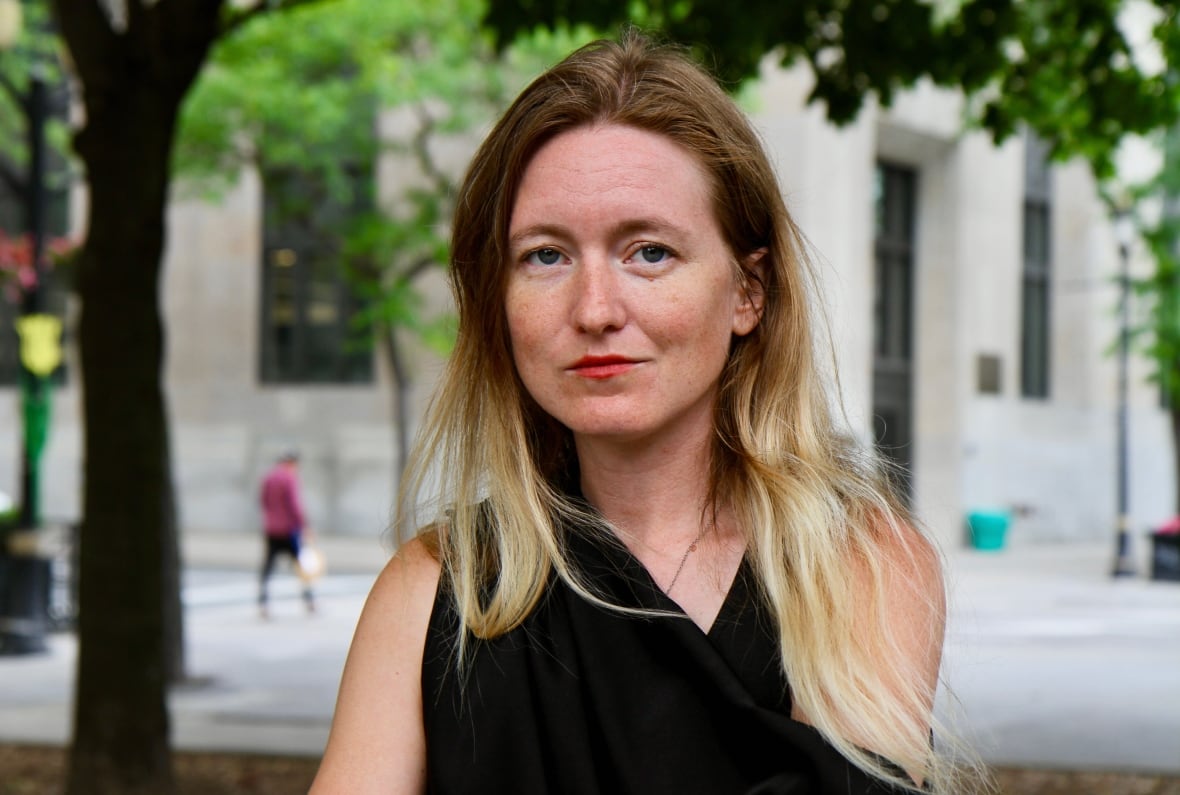 Woman stands outside on downtown street 