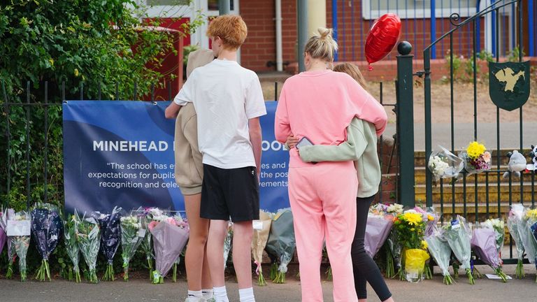 People left flowers outside school last week. Pic: PA