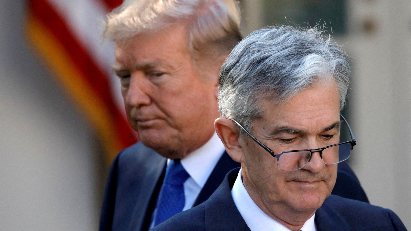 US President Donald Trump appears next to Jerome Powell