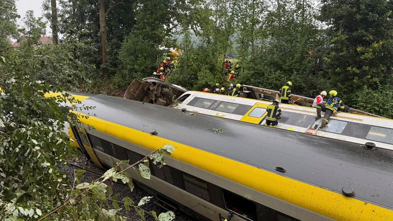 Rescue workers search for passengers in a derailed train, Zwiefaltendorf. Pic: AP / dpa