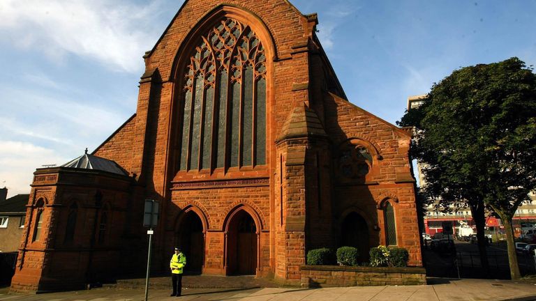 A policeman stands outside St Patrick's Church in Glasgow, where a body was found last night. Police hunting for missing student Angelika Kl